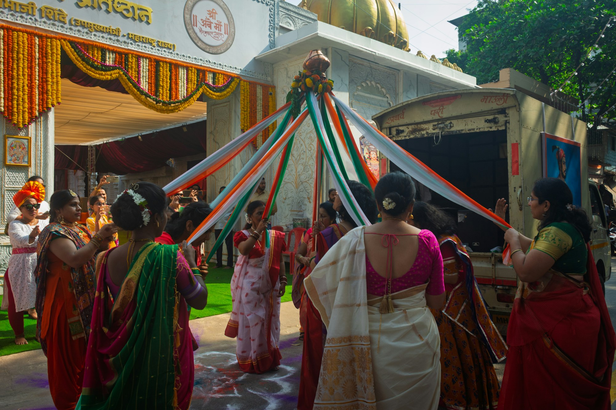 Women in saris celebrating with tricolor ribbons